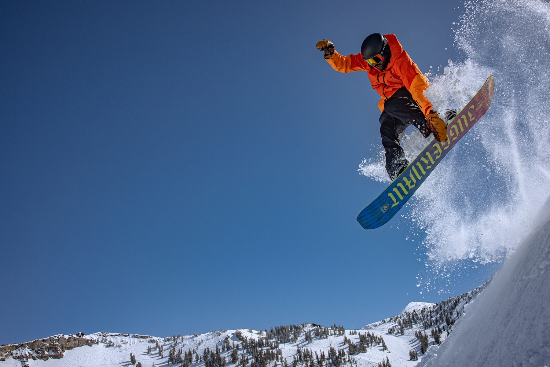 Snowboarder jumps - riding the ski bus utah