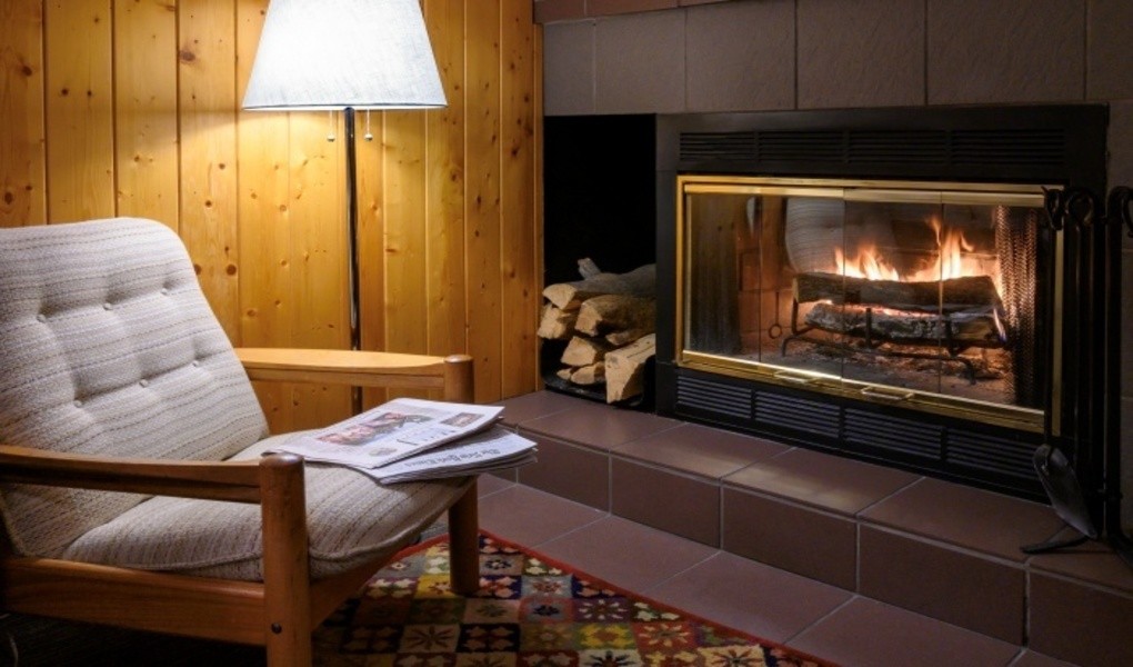 Room with wood burning fireplace